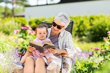 Image showing grandmother and baby granddaughter reading book