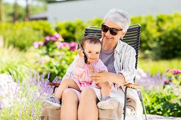 Image showing grandmother and baby granddaughter with smartphone