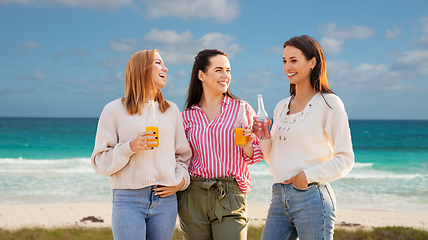 Image showing young women with non alcoholic drinks on beach