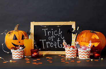 Image showing pumpkins, candies and halloween decorations