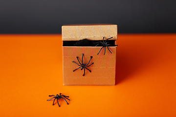 Image showing toy spiders crawling out of gift box on halloween