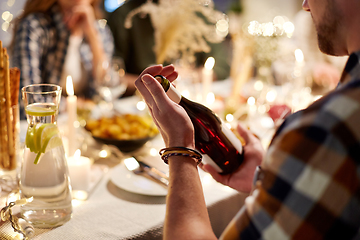 Image showing happy friends with red wine at christmas party