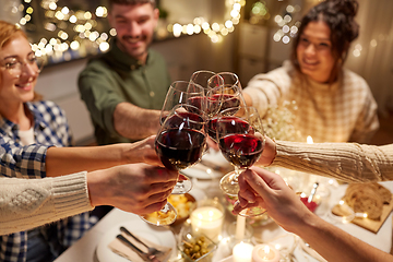 Image showing happy friends drinking red wine at christmas party