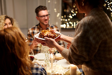 Image showing happy friends having christmas dinner at home