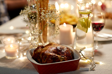 Image showing roast chicken on served table at home dinner party