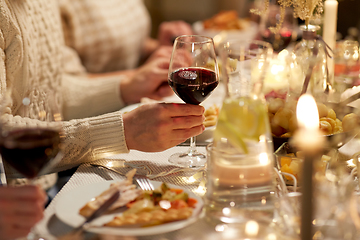 Image showing friends drinking red wine at christmas party