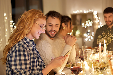 Image showing friends with cellphone having dinner party at home