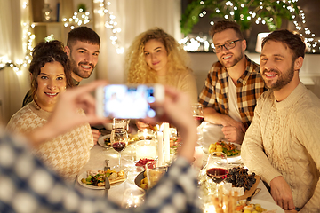 Image showing friends photographing at christmas dinner party