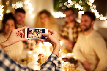 Image showing friends photographing at christmas dinner party