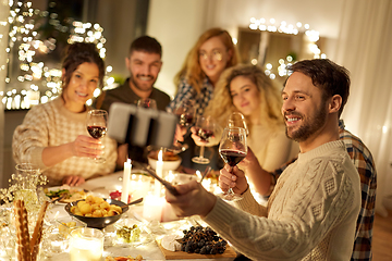 Image showing friends taking selfie at christmas dinner party