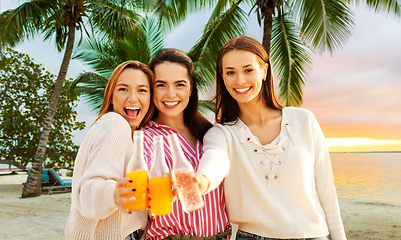 Image showing young women toasting non alcoholic drinks on beach