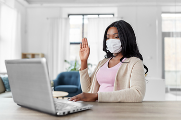 Image showing woman in mask with laptop having video call