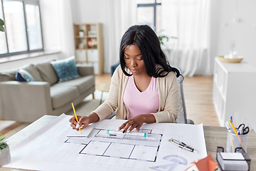 Image showing female architect with house model and blueprint