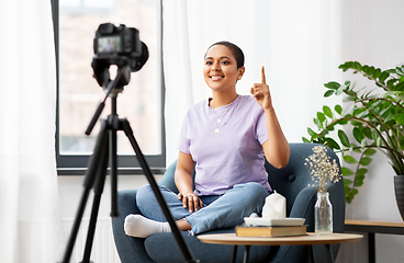 Image showing female blogger with camera video blogging at home