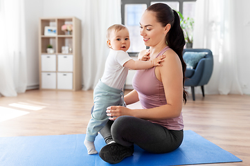 Image showing happy mother with little baby at home