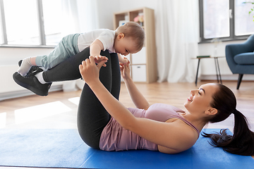 Image showing happy mother with little baby exercising at home