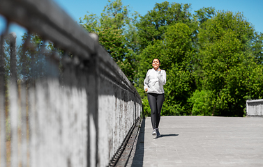 Image showing african american woman running outdoors