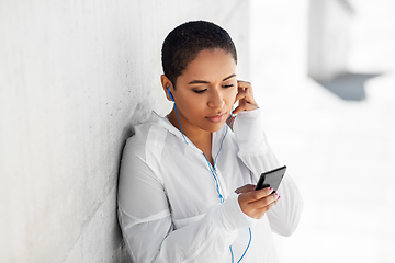 Image showing african american woman with earphones and phone