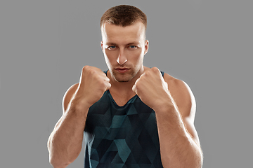 Image showing young man or bodybuilder showing his fists