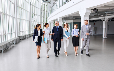 Image showing business people walking along office building