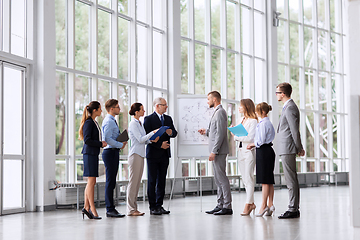 Image showing business team with scheme on flip chart at office