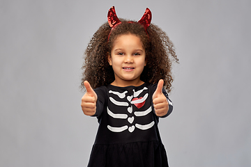 Image showing girl in black dress and devil's horns on halloween