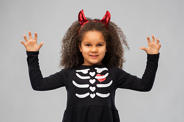 Image showing girl in black dress and devil's horns on halloween