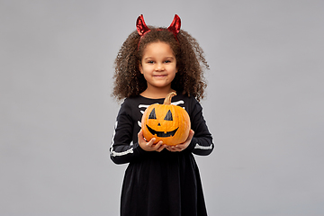 Image showing girl in halloween costume with jack-o-lantern