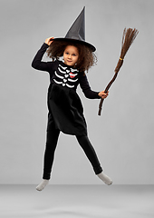 Image showing girl in black witch hat with broom on halloween