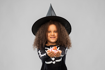 Image showing girl with candies trick-or-treating on halloween