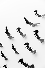 Image showing flock of black paper bats over white background