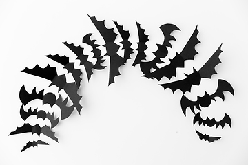 Image showing flock of black paper bats over white background