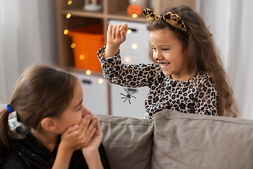 Image showing girls in halloween costumes playing with spider