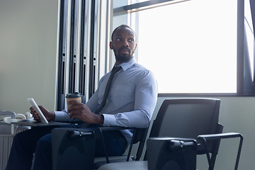 Image showing Young businessman waiting for departure in airport, work trip, business lifestyle