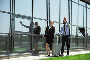 Image showing Meeting of young business partners after arriving to end point of business trip