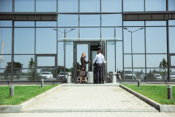 Image showing Meeting of young business partners after arriving to end point of business trip