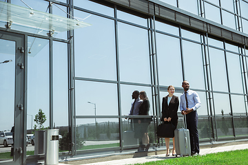 Image showing Meeting of young business partners after arriving to end point of business trip