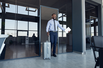 Image showing Young businessman after departure in airport, work trip, business lifestyle