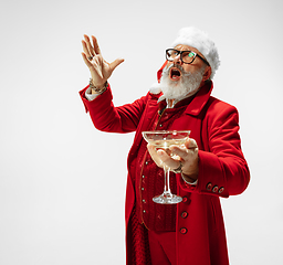 Image showing Modern stylish Santa Claus in red fashionable suit isolated on white background