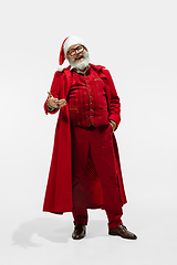 Image showing Modern stylish Santa Claus in red fashionable suit isolated on white background