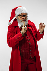 Image showing Modern stylish Santa Claus in red fashionable suit isolated on white background