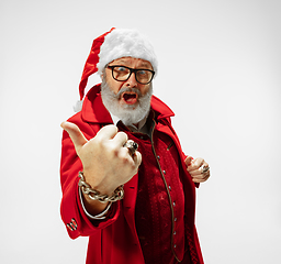 Image showing Modern stylish Santa Claus in red fashionable suit isolated on white background