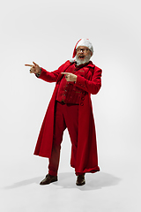 Image showing Modern stylish Santa Claus in red fashionable suit isolated on white background