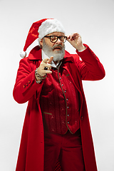 Image showing Modern stylish Santa Claus in red fashionable suit isolated on white background