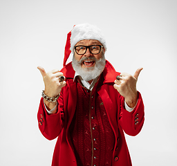 Image showing Modern stylish Santa Claus in red fashionable suit isolated on white background