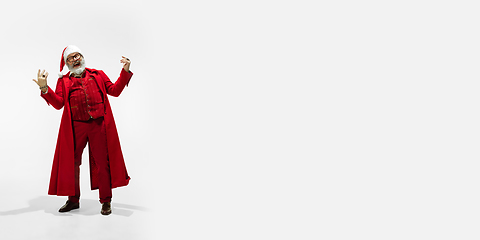 Image showing Modern stylish Santa Claus in red fashionable suit isolated on white background