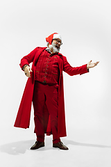 Image showing Modern stylish Santa Claus in red fashionable suit isolated on white background