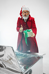 Image showing Modern stylish Santa Claus in red fashionable suit isolated on white background