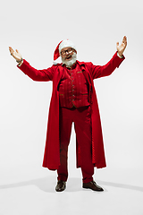 Image showing Modern stylish Santa Claus in red fashionable suit isolated on white background