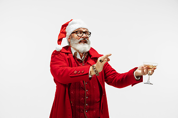 Image showing Modern stylish Santa Claus in red fashionable suit isolated on white background